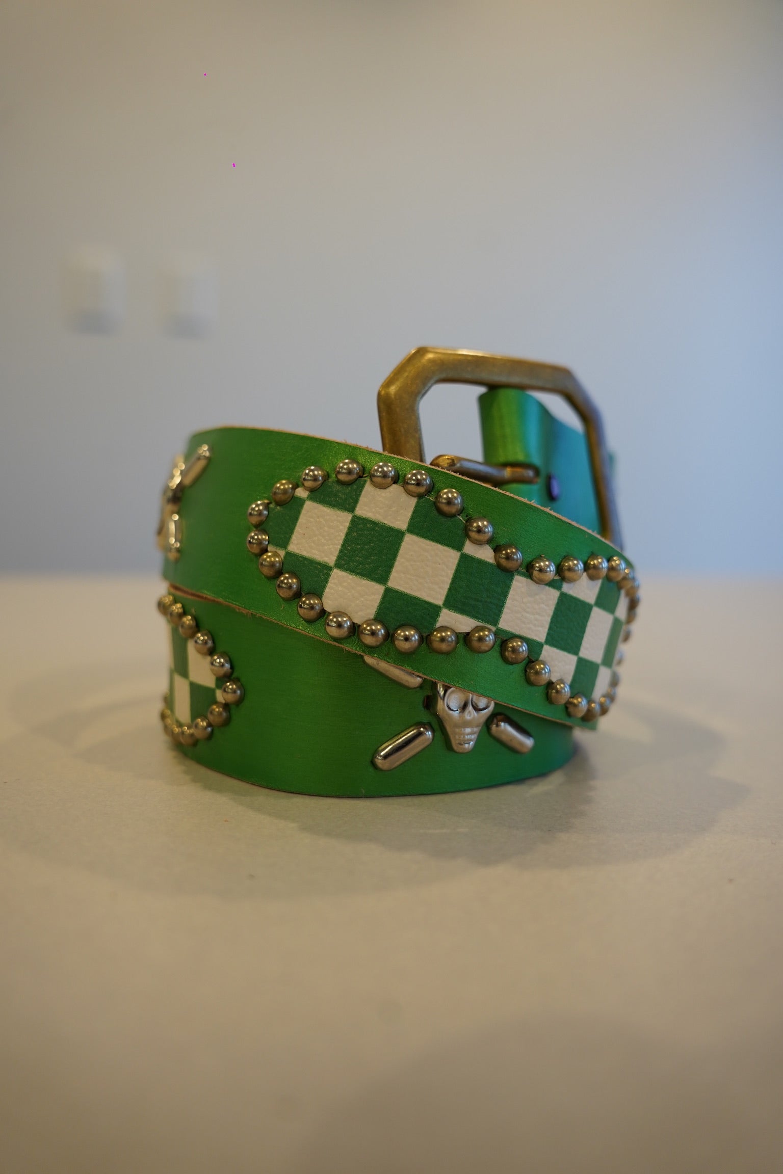 Vintage green checkered woven canvas belt with silver pyramid studs and antique metal buckle