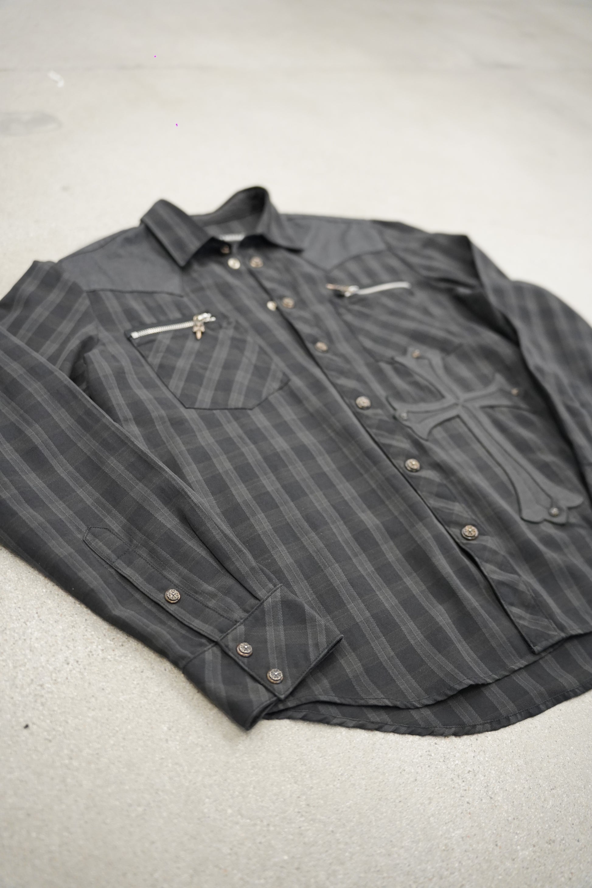 Chrome Hearts grey plaid flannel angled view showing zipper chest pockets and leather cross applique