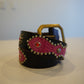 Vintage black leather belt with pink snakeskin inlays, silver studs, red gemstones and brass buckle.