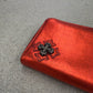 Chrome Hearts red plus cross long wallet angled detail of black embroidered cross patch on red leather