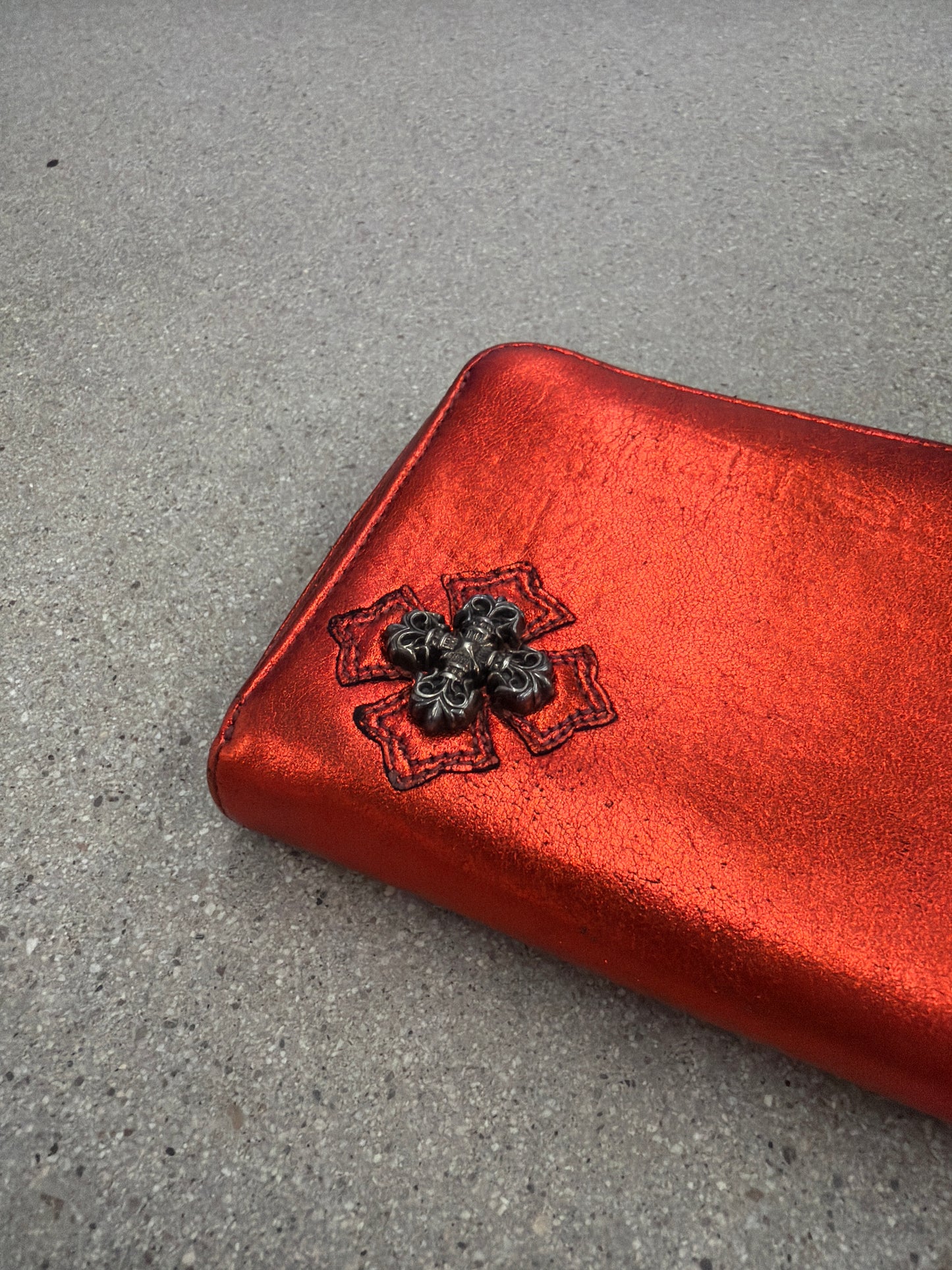 Chrome Hearts red plus cross long wallet angled detail of black embroidered cross patch on red leather