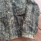 Louis Vuitton blue monogram denim jacket detail view highlighting embossed LV stars across denim.