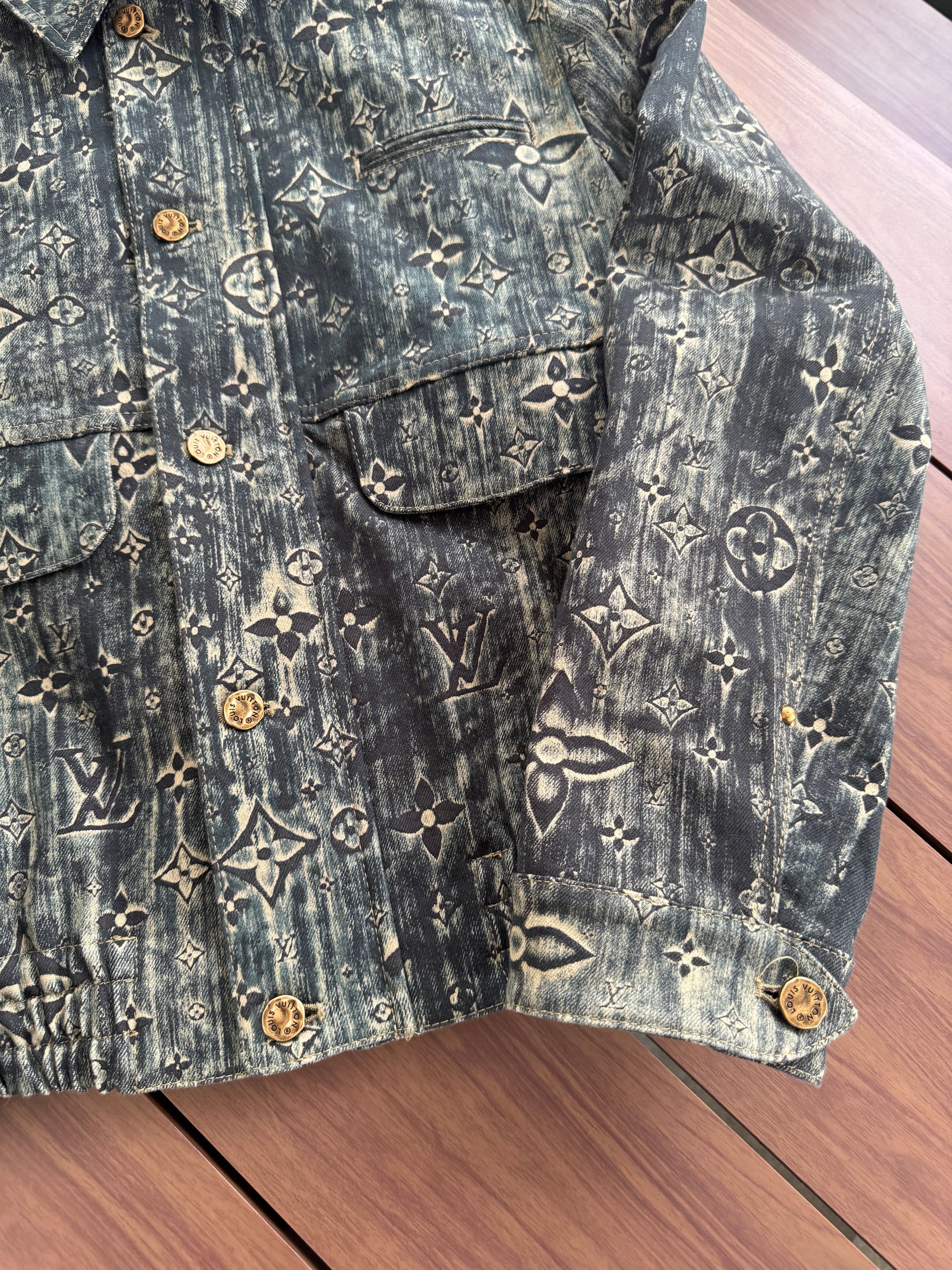 Louis Vuitton blue monogram denim jacket detail view highlighting embossed LV stars across denim.