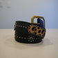 Vintage black leather belt coiled with cheetah pony hair patches, silver studs and brass square buckle