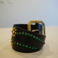 Vintage black leather studded belt coiled view, green rhinestones, gold floral conchos and brass square buckle.
