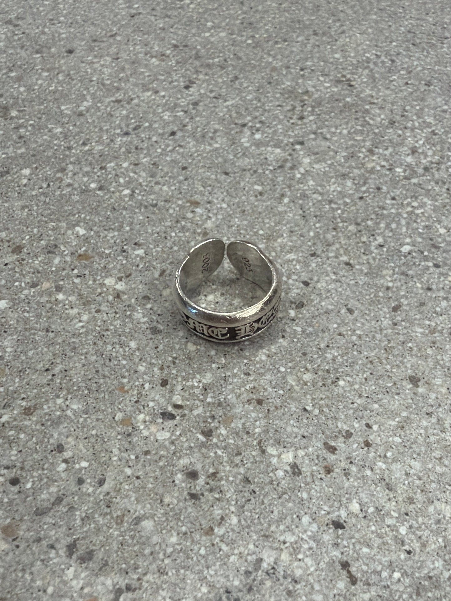 Chrome Hearts silver scroll label ring with sterling band and gothic engraved CH scroll detail.