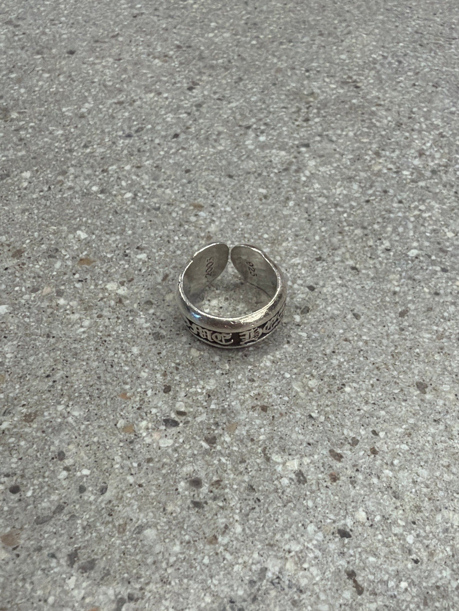 Chrome Hearts silver scroll label ring with sterling band and gothic engraved CH scroll detail.