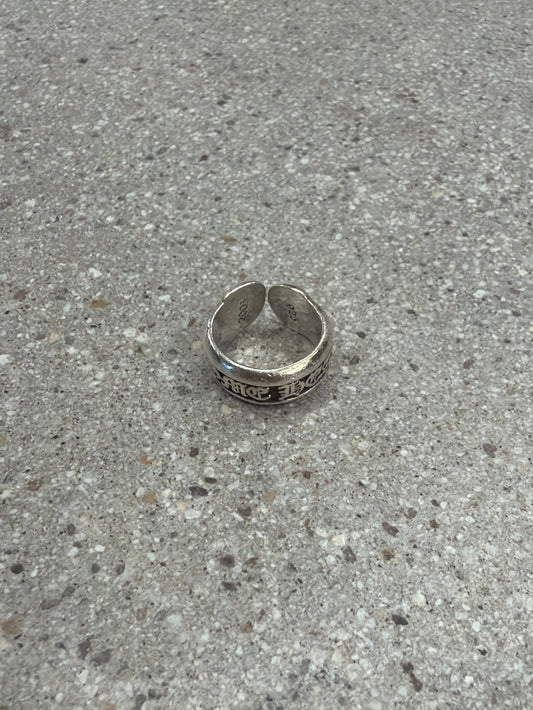 Chrome Hearts silver scroll label ring with sterling band and gothic engraved CH scroll detail.