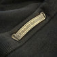 Chrome Hearts Paper Jam sweatpants close-up of metallic gothic scroll brand label on black fabric