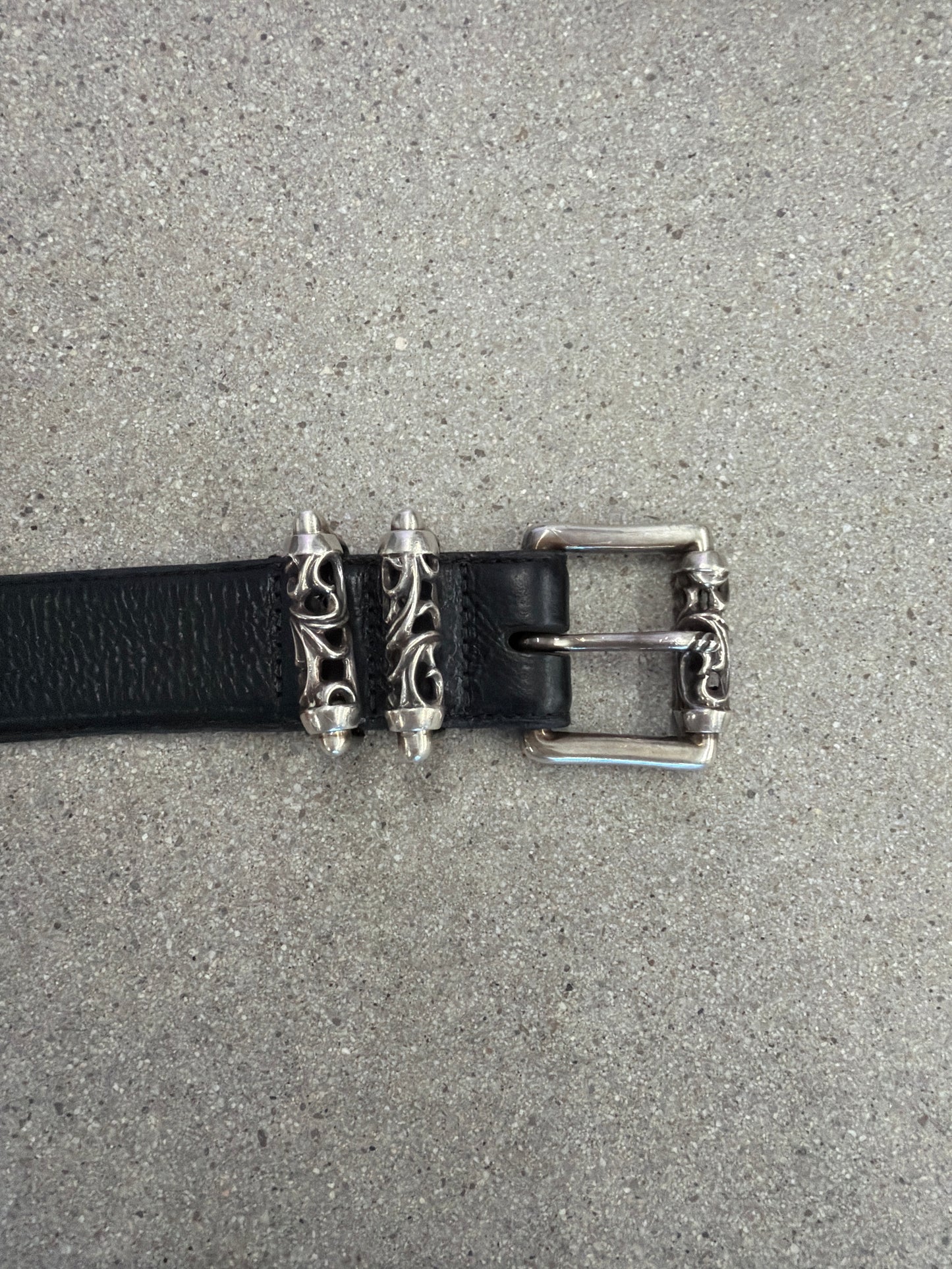 Chrome Hearts Celtic Roller belt buckle detail showing engraved silver dagger keepers on black leather