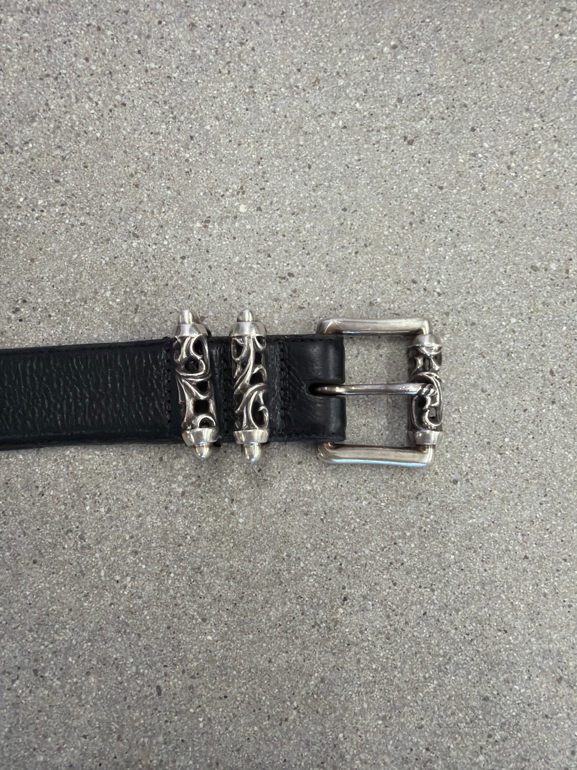 Chrome Hearts Celtic Roller belt buckle detail showing engraved silver dagger keepers on black leather