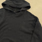 Chrome Hearts black hoodie close-up of embroidered cross logo detail at front kangaroo pocket