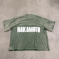 Satoshi Nakamoto green oversized impact logo tee back with bold white NAKAMOTO block lettering