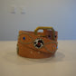 Vintage tan leather belt coiled with brass buckle, silver bead trim, leopard inlay medallions and jewel studs.