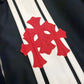 Chrome Hearts black Cobra racing jacket detail of red leather double cross patches over white leather stripes