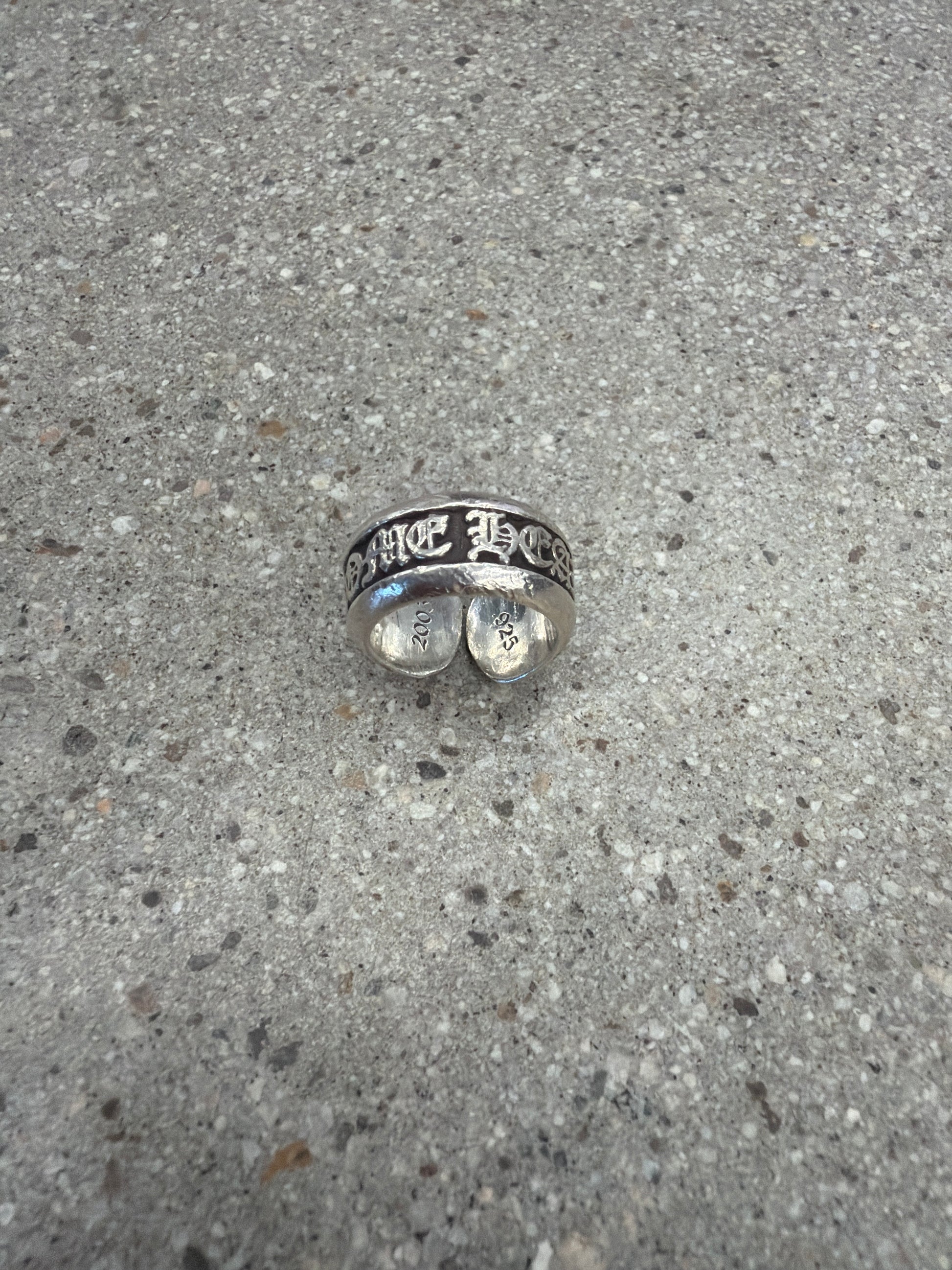 Chrome Hearts sterling silver scroll label ring profile showing oxidized scroll engraving.