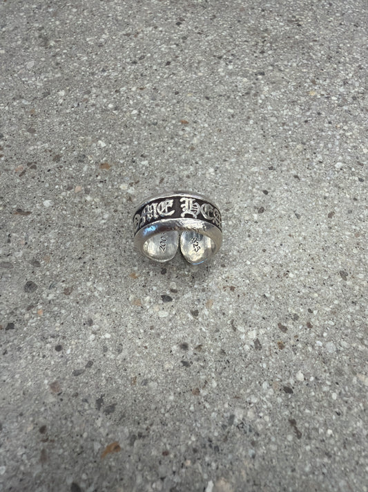 Chrome Hearts sterling silver scroll label ring profile showing oxidized scroll engraving.