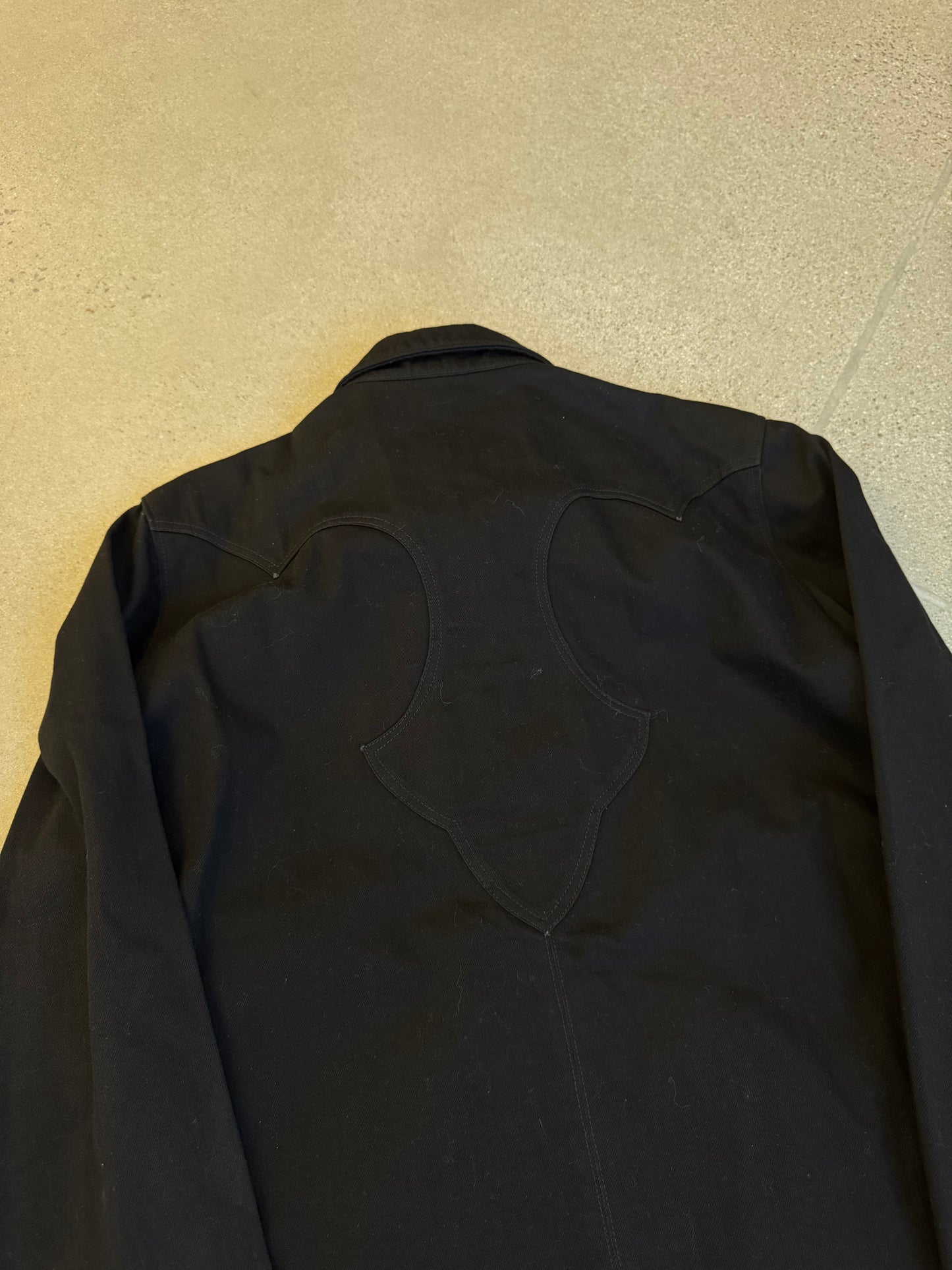 Chrome Hearts black western jacket back yoke detail showing heart-shaped panel stitching close up