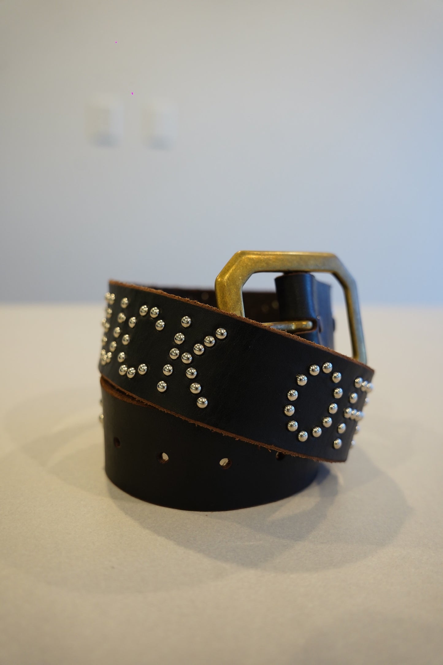 Vintage black leather studded belt with orange Fuck Off text print and silver pyramid stud detailing