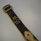 Buckle detail of vintage brown leather studded belt with brass hardware and leopard hair-on appliques