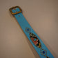 Vintage light blue snakeskin studded belt detail showing pink, green and yellow beadwork and gem accents