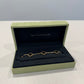 Van Cleef & Arpels onyx Alhambra bracelet close-up of 5 clover motifs in 18k yellow gold chain