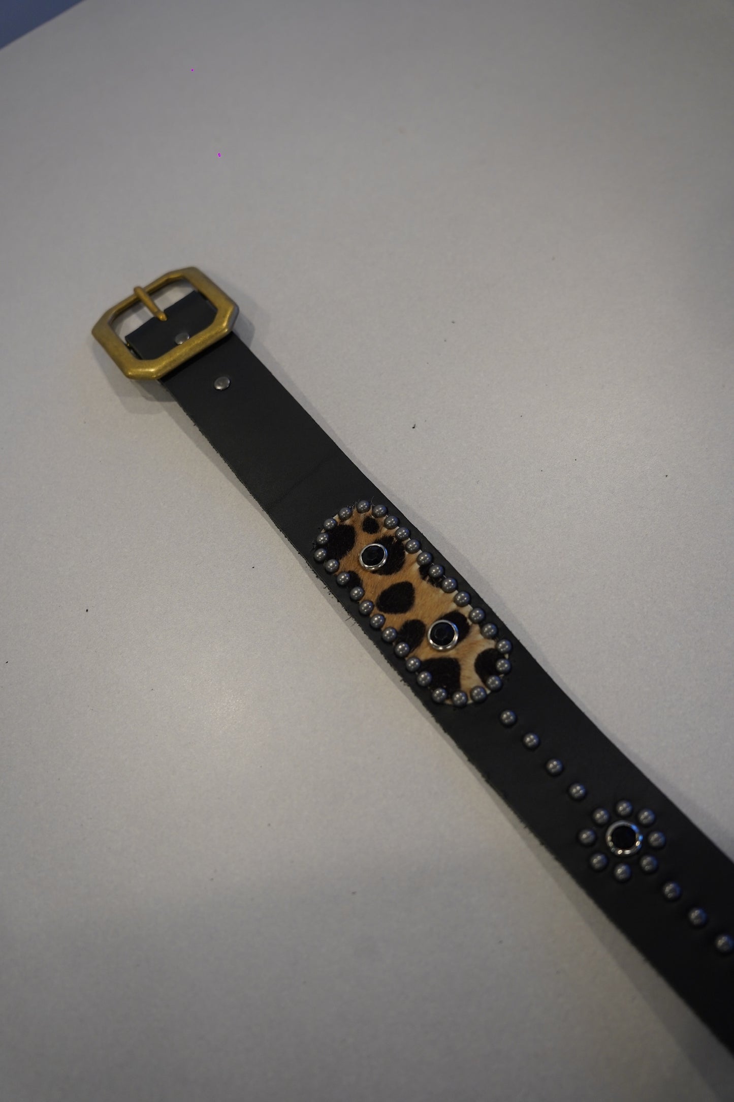 Vintage studded black leather belt detail with cheetah print calf hair inset and silver rivet trim