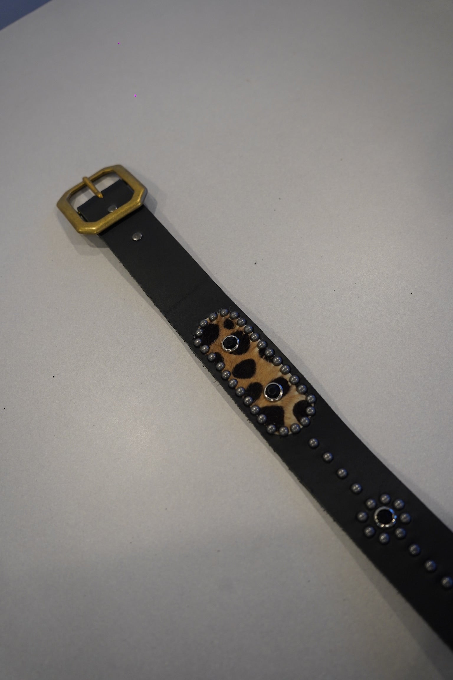 Vintage studded black leather belt detail with cheetah print calf hair inset and silver rivet trim