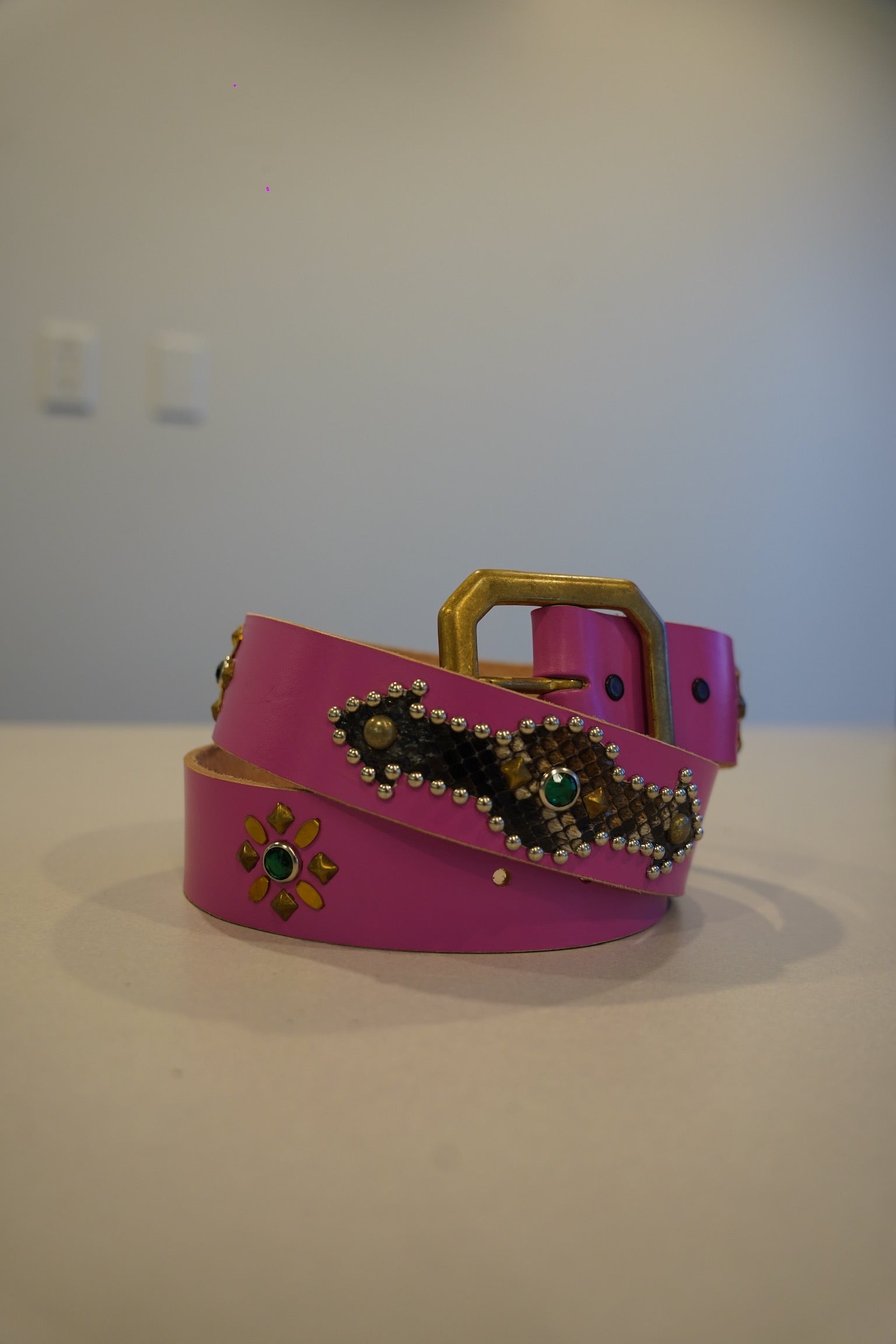 Vintage pink snakeskin leather belt with pyramid stud trim and silver-tone buckle, full length view