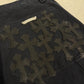 Chrome Hearts carpenter shorts close-up of black leather flooded cross patches stitched on back pocket