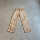 Vintage Carhartt tan double-knee carpenter pants in faded duck canvas with reinforced knee panels and utility loops.