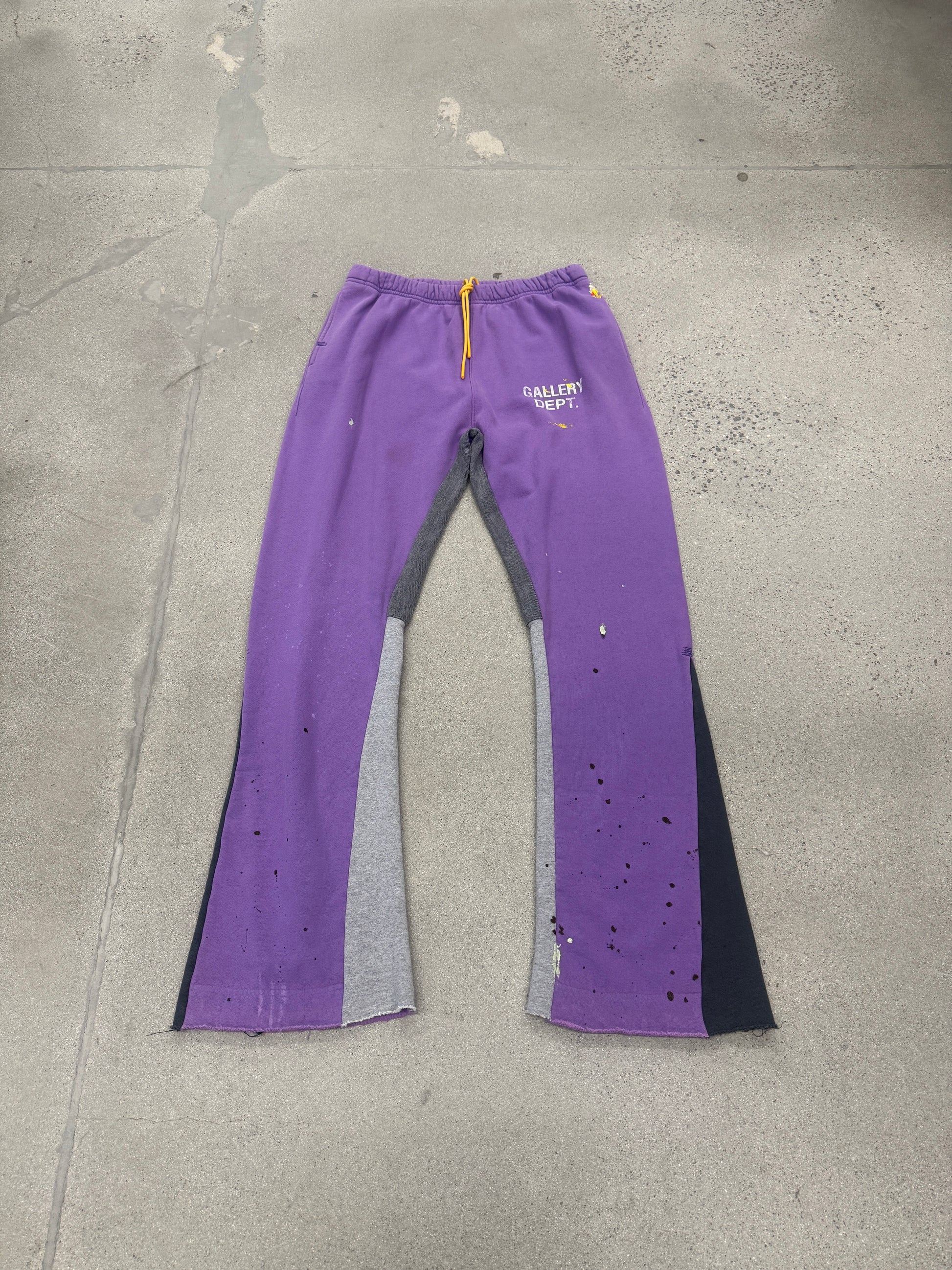 Gallery Dept purple painted flare sweatpants laid flat, showing flared hem and signature paint-splattered finish