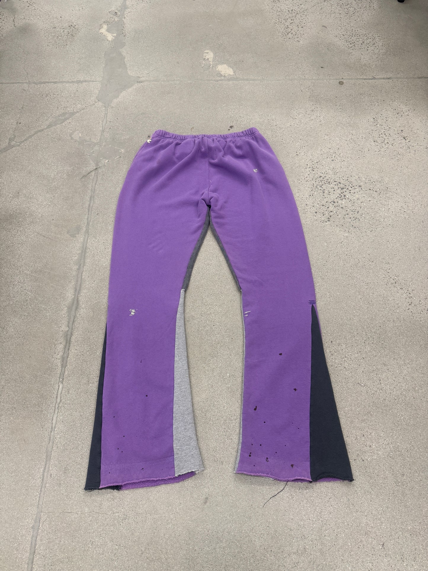 Gallery Dept purple painted flare sweatpants detail view, close-up of violet paint streaks on grey fleece