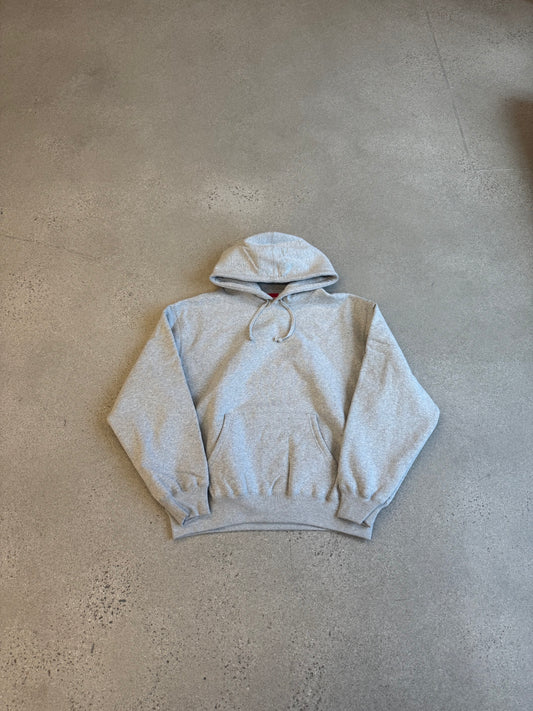 Supreme heather gray pullover hoodie front view with kangaroo pocket and red box logo tag at neck