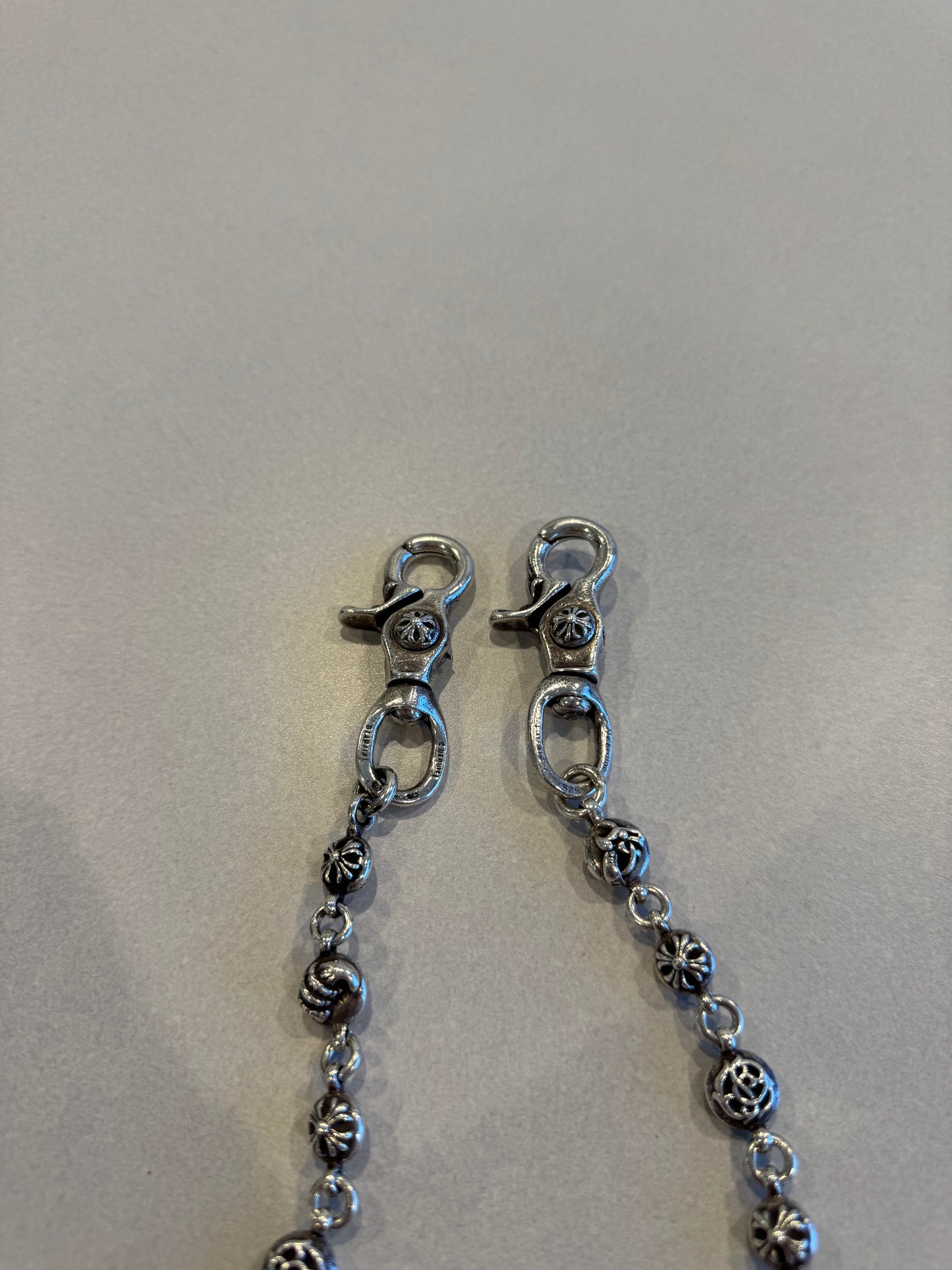Chrome Hearts wallet chain close-up of double lobster clasp ends and engraved silver cross ball links
