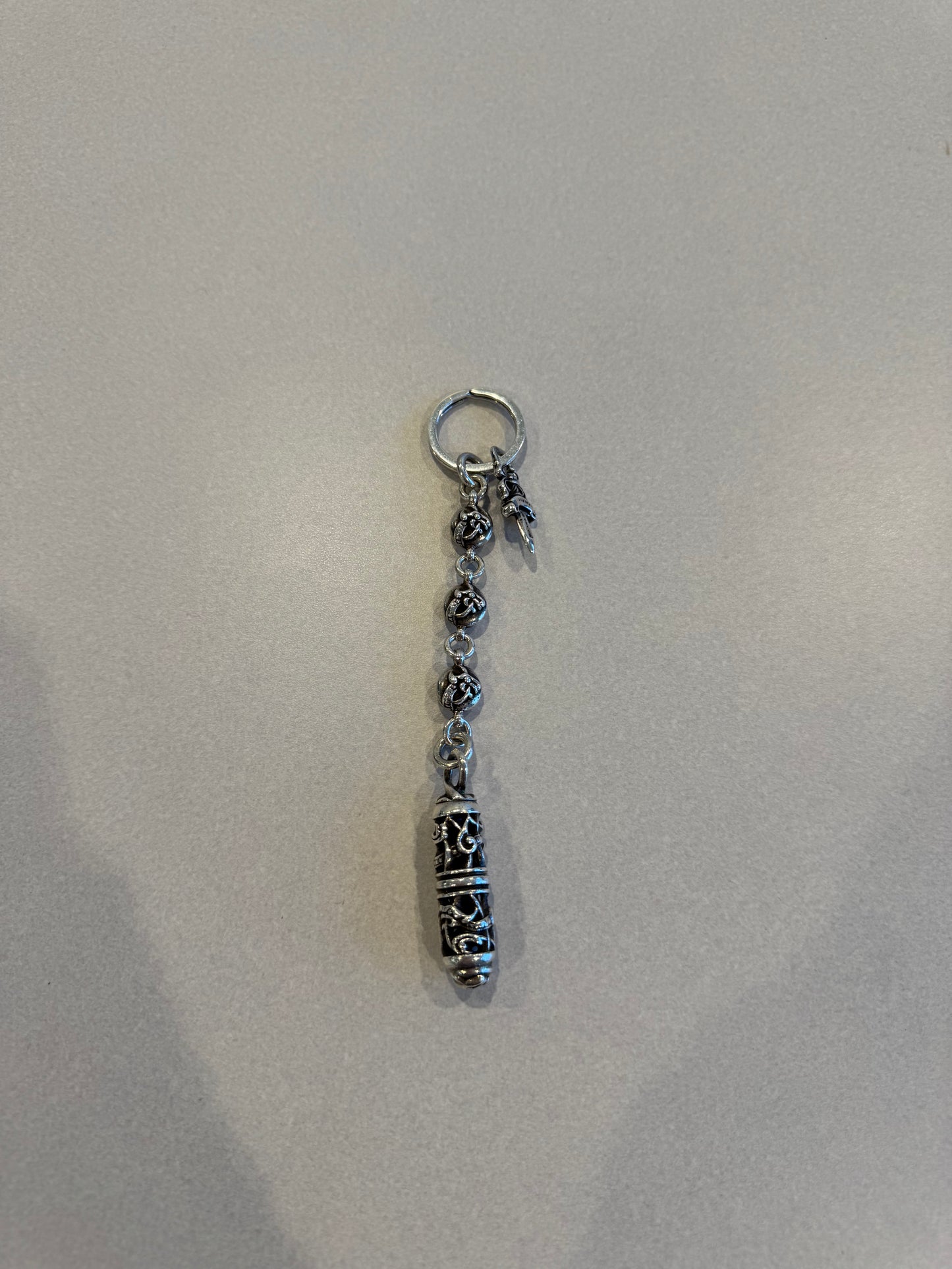 Chrome Hearts Celtic roller ball dagger key ring with silver bead chain, dagger charm and engraved capsule