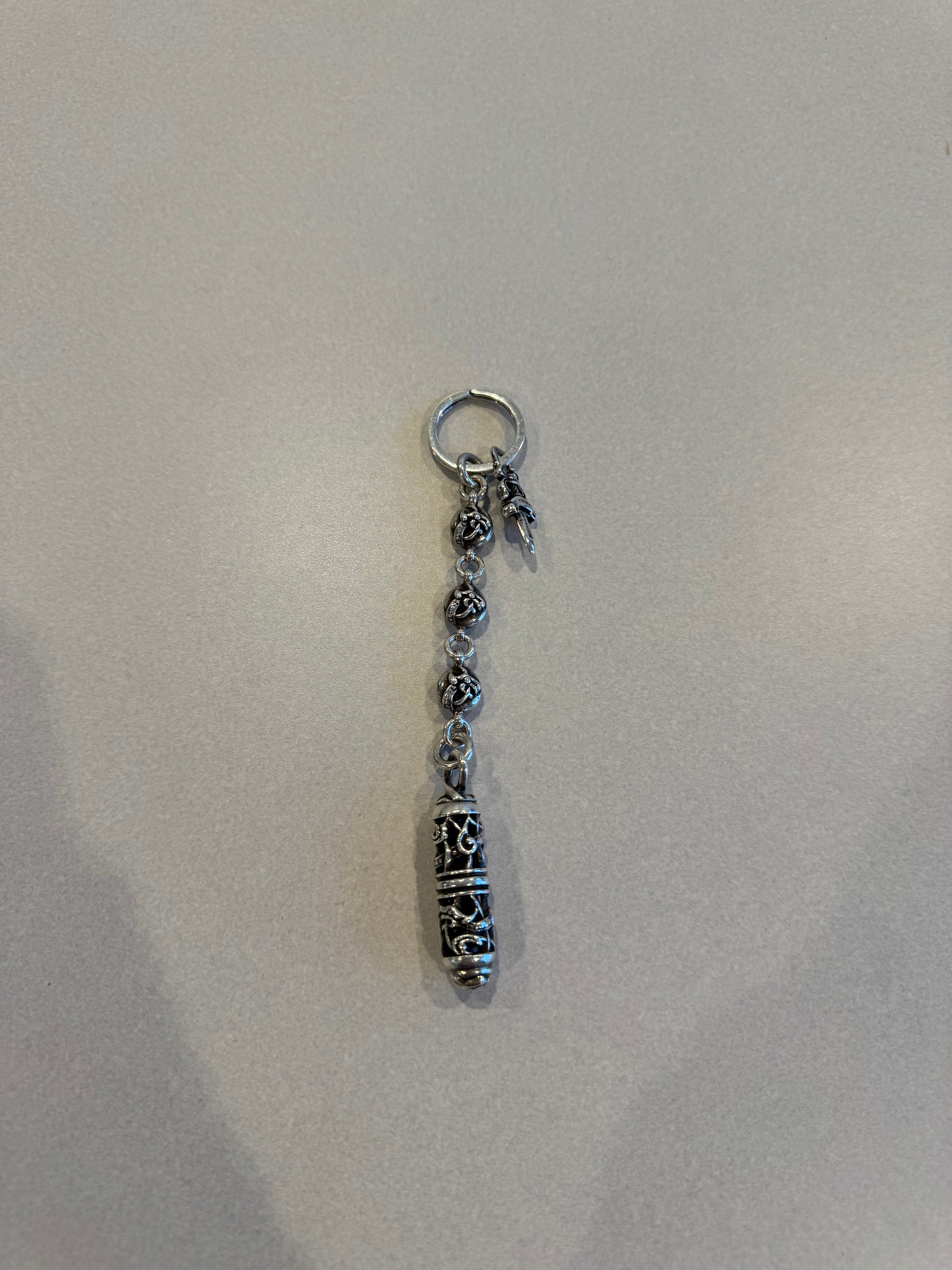 Chrome Hearts Celtic roller ball dagger key ring with silver bead chain, dagger charm and engraved capsule