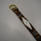 Custom cowhide FU belt full length view showing pyramid stud pattern and aged brown leather strap.