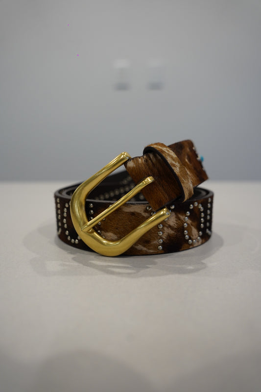 Custom studded brown leather belt detail of horseshoe buckle with turquoise inlay and silver conchos.