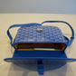 Goyard blue Belvedere PM shoulder bag opened revealing yellow interior lining and pebbled leather pocket trim.