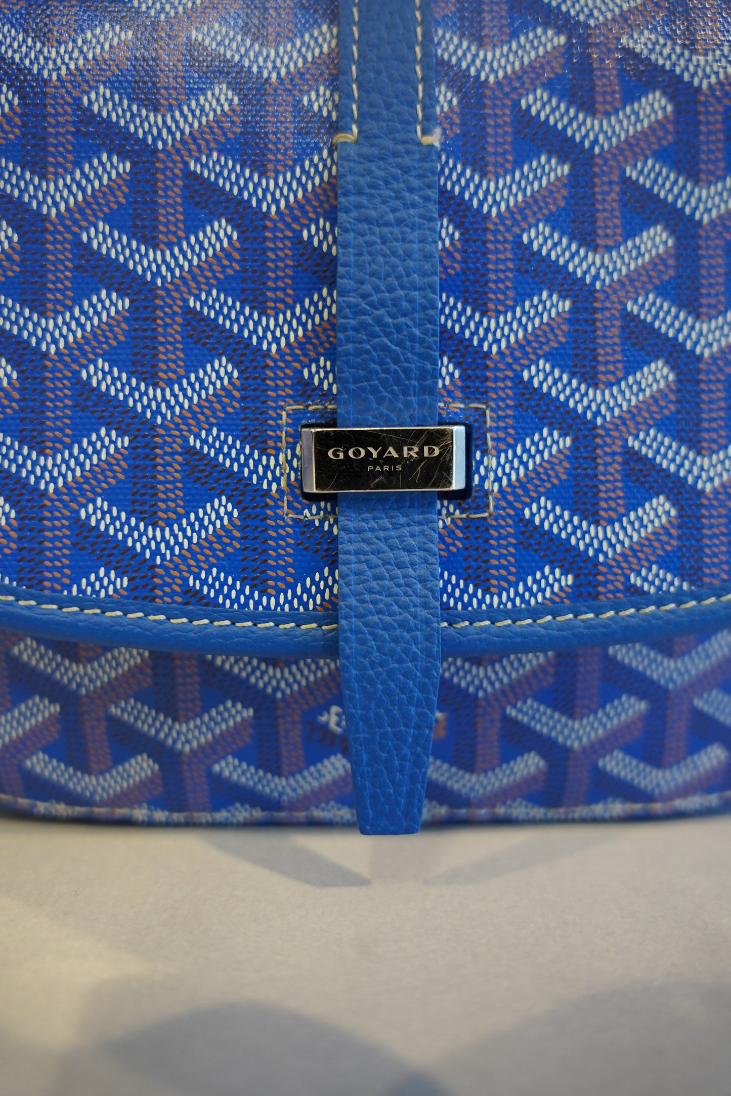 Goyard Belvedere PM blue Goyardine crossbody bag side view with adjustable leather strap and clean back panel.