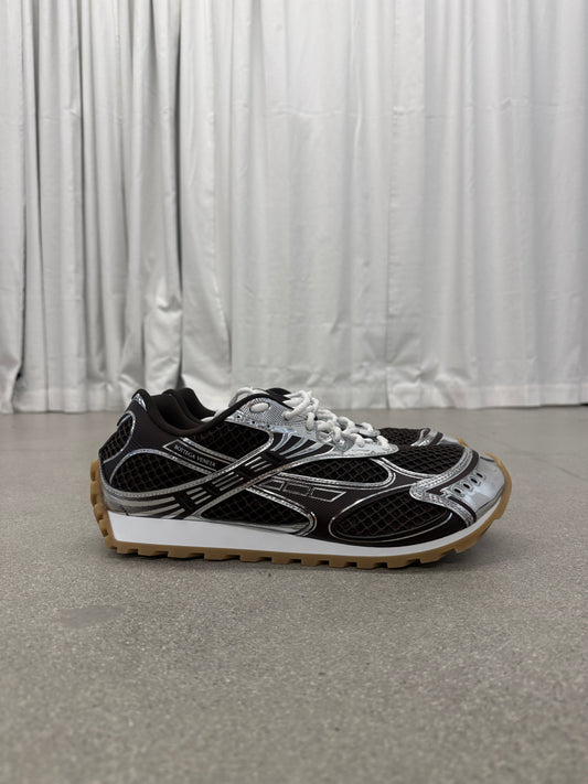 Bottega Veneta brown Orbit sneakers side profile with mesh upper, silver chrome overlays and gum rubber sole