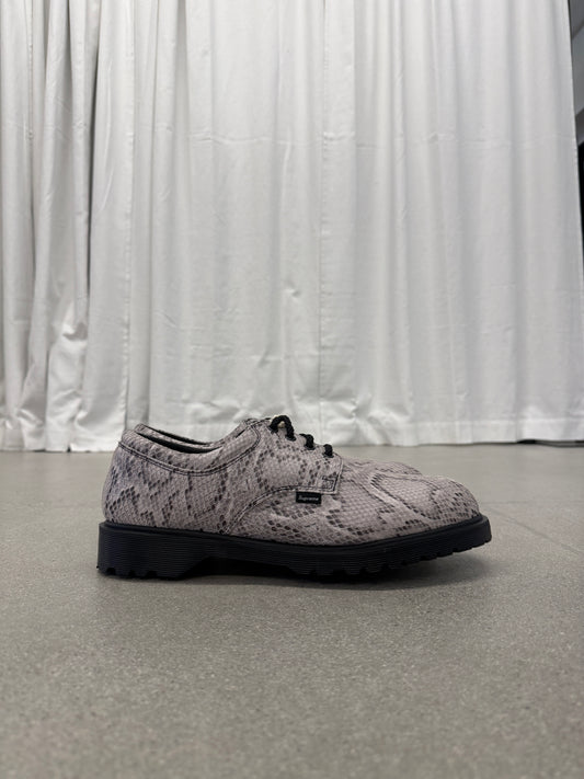 Supreme Dr Martens Postal 4-eye shoe side view in grey python snakeskin with chunky black lugged sole