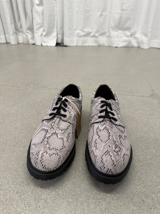 Supreme Dr Martens snakeskin Postal derby front pair view with 4-eye lacing and tan inner tongue tag