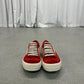 Side profile of Rick Owens Carnelian sneakers in aged grey leather with extended toe and rubber wrap sole.