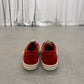 Rick Owens Carnelian sneakers shown from rear angle highlighting elongated heel and distressed patina.