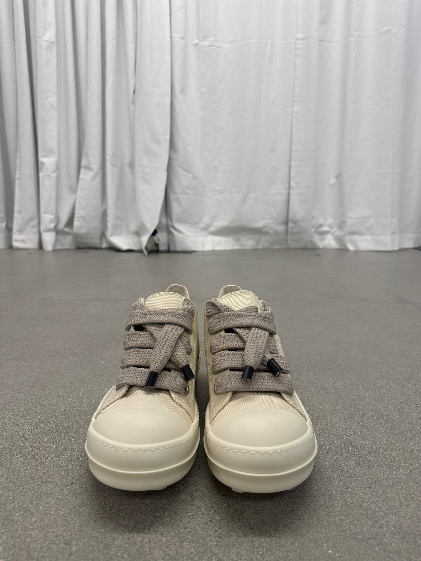Front view of Rick Owens DRKSHDW milk canvas sneakers with thick taupe jumbo laces and white cap toes