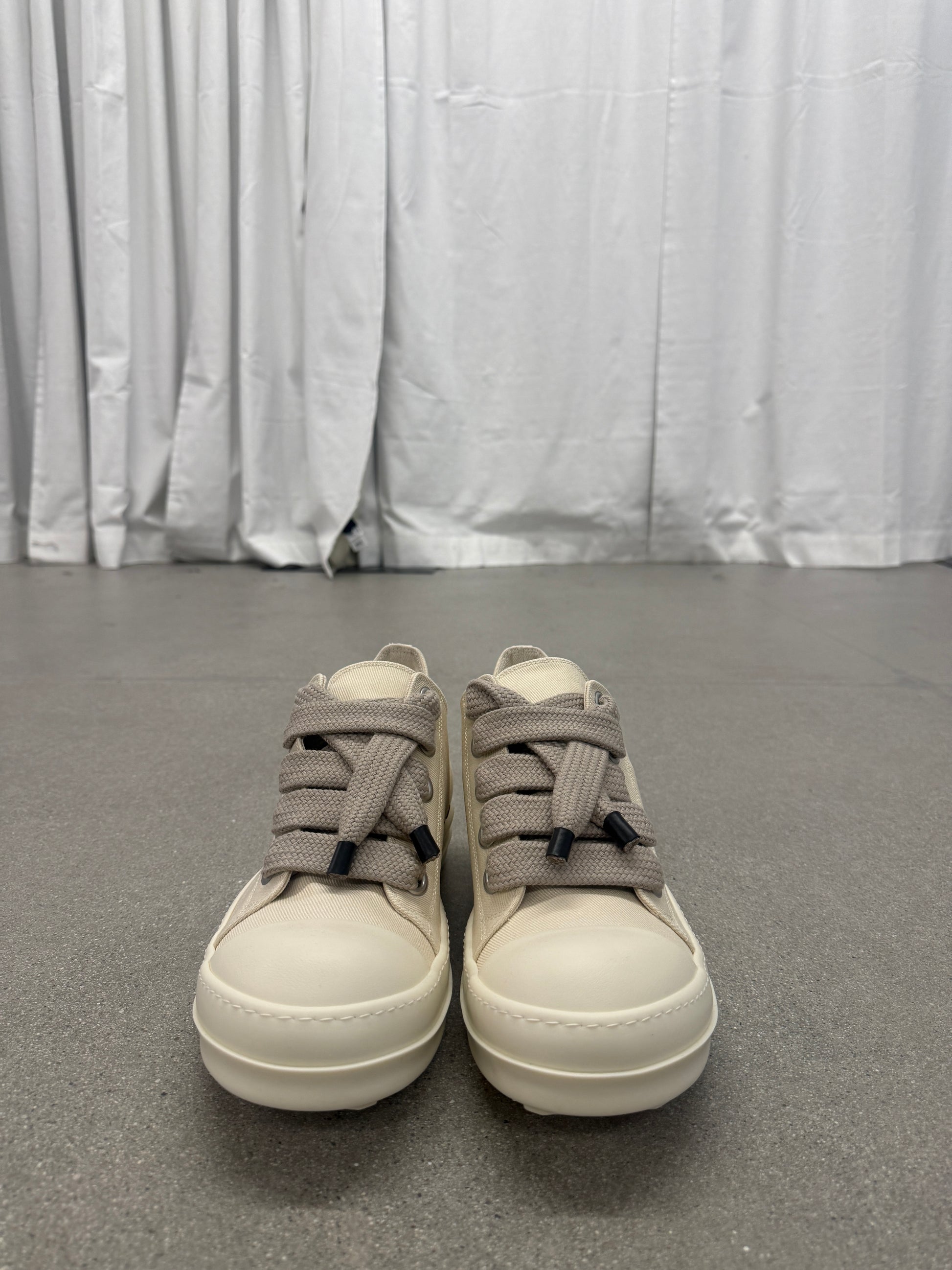 Front view of Rick Owens DRKSHDW milk canvas sneakers with thick taupe jumbo laces and white cap toes