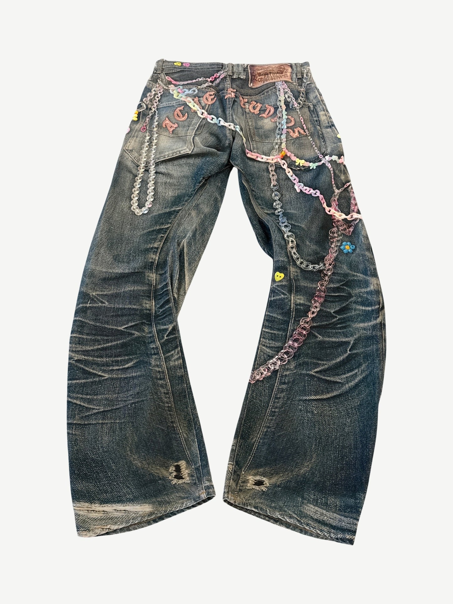 Back view of Acne Studios 1981 trompe l'oeil keychain jeans with rear leather patch and printed chain and pearl motifs