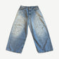 Acne Studios 2023M loose fit jeans front, light wash baggy denim with white paint splatter and dirt smudges.